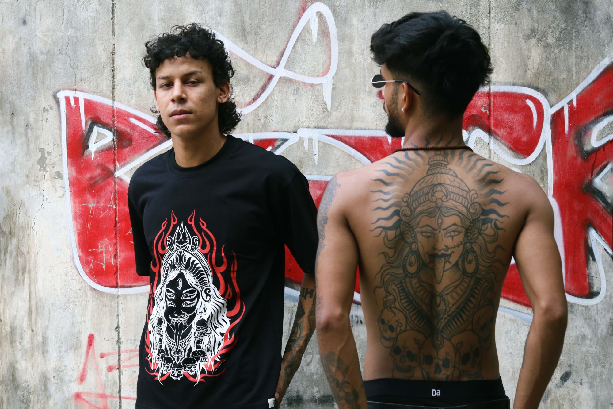 Mahakali Oversized Tee worn against a graffiti wall