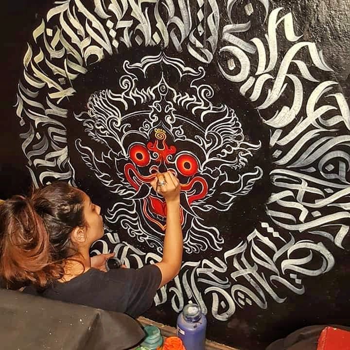 The founder painting a wrathful face inside a ring of calligraphy