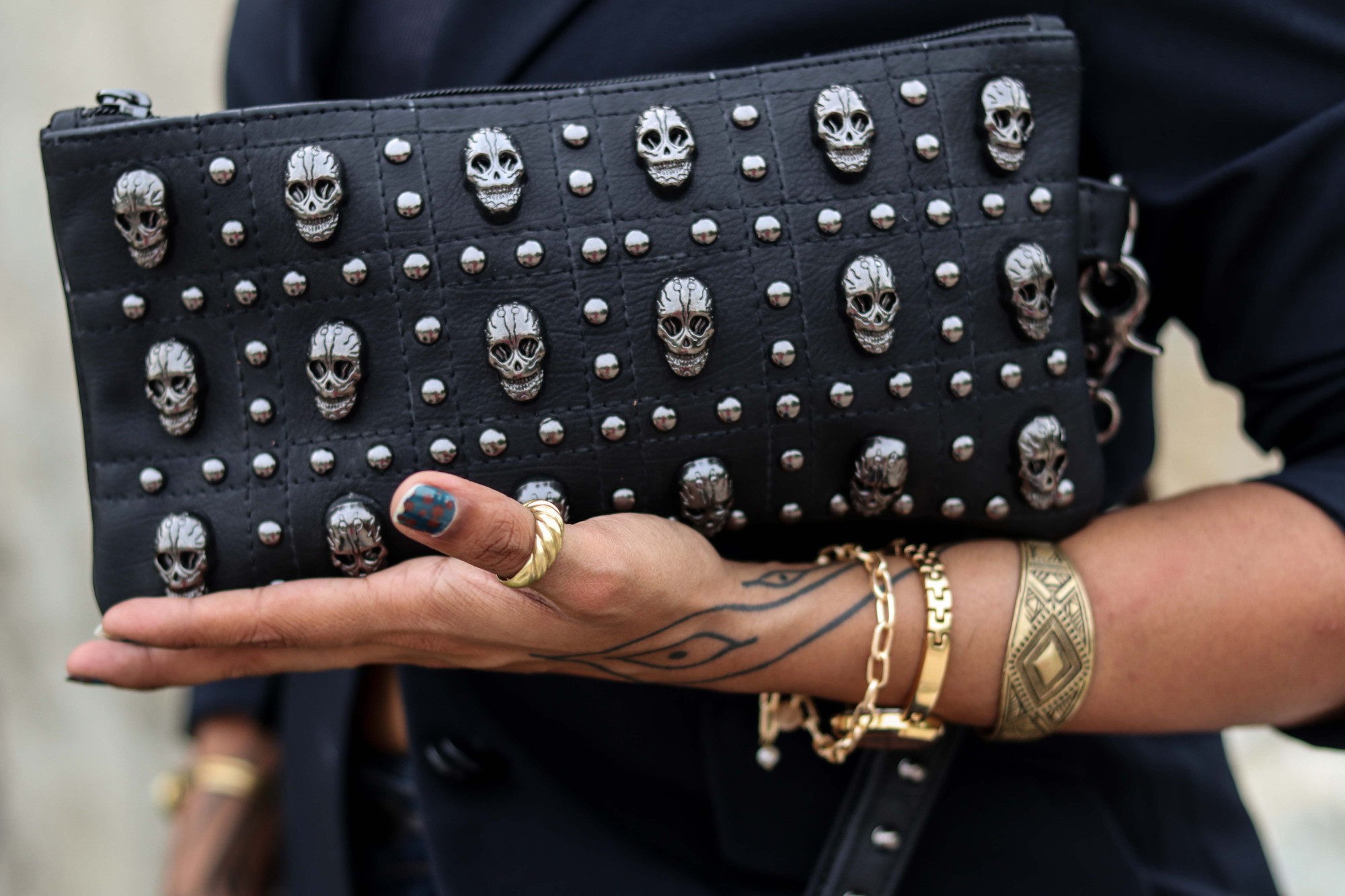 Dakinii worn on the street: a skull-studded leather clutch, printed oversized tees